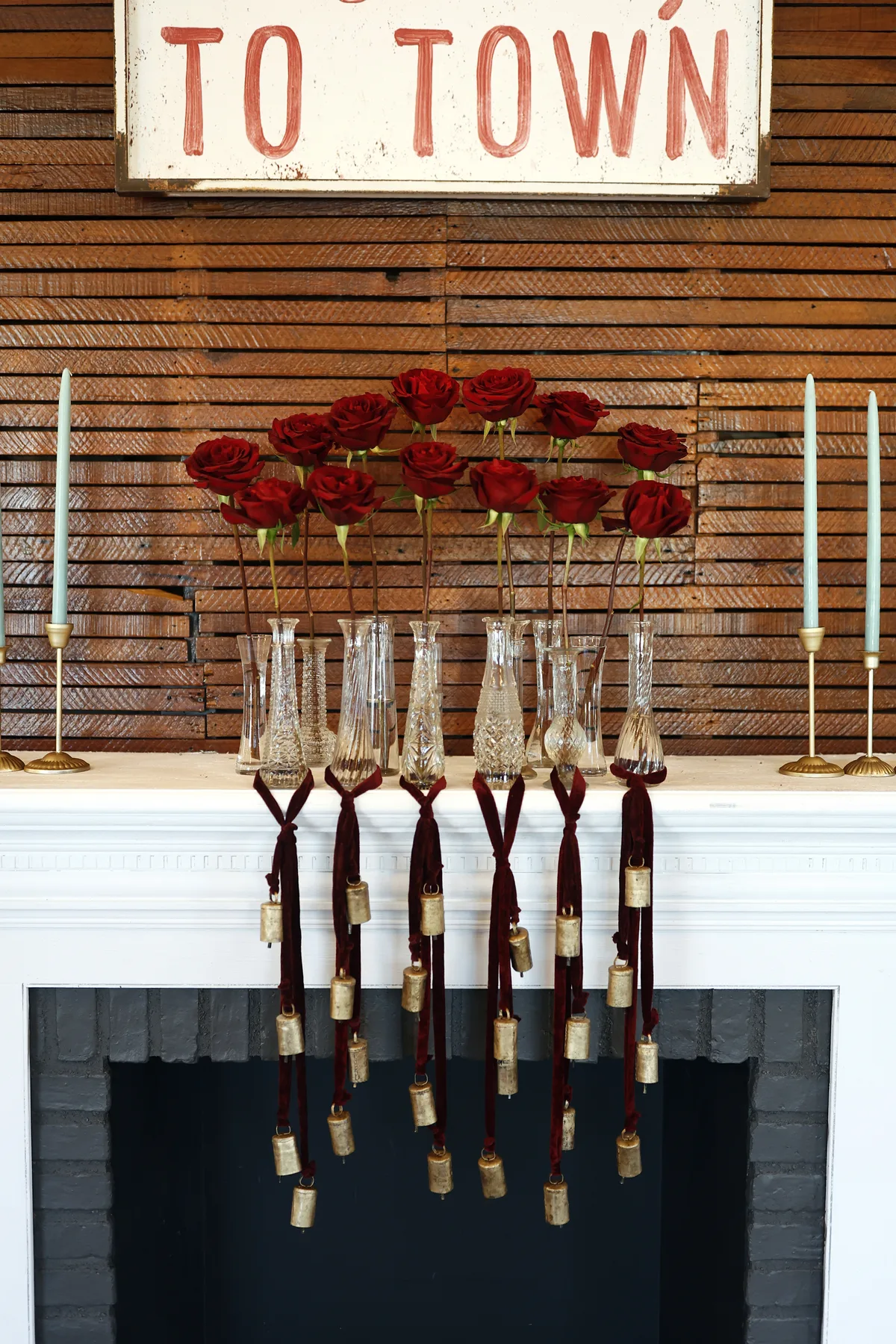 Holiday candles and greenery beside the historic fireplace